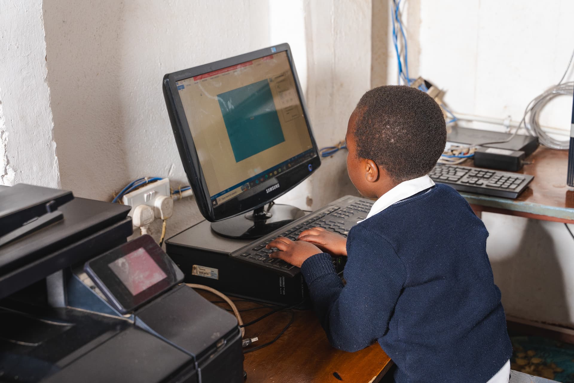Primary pupils learning computer skills