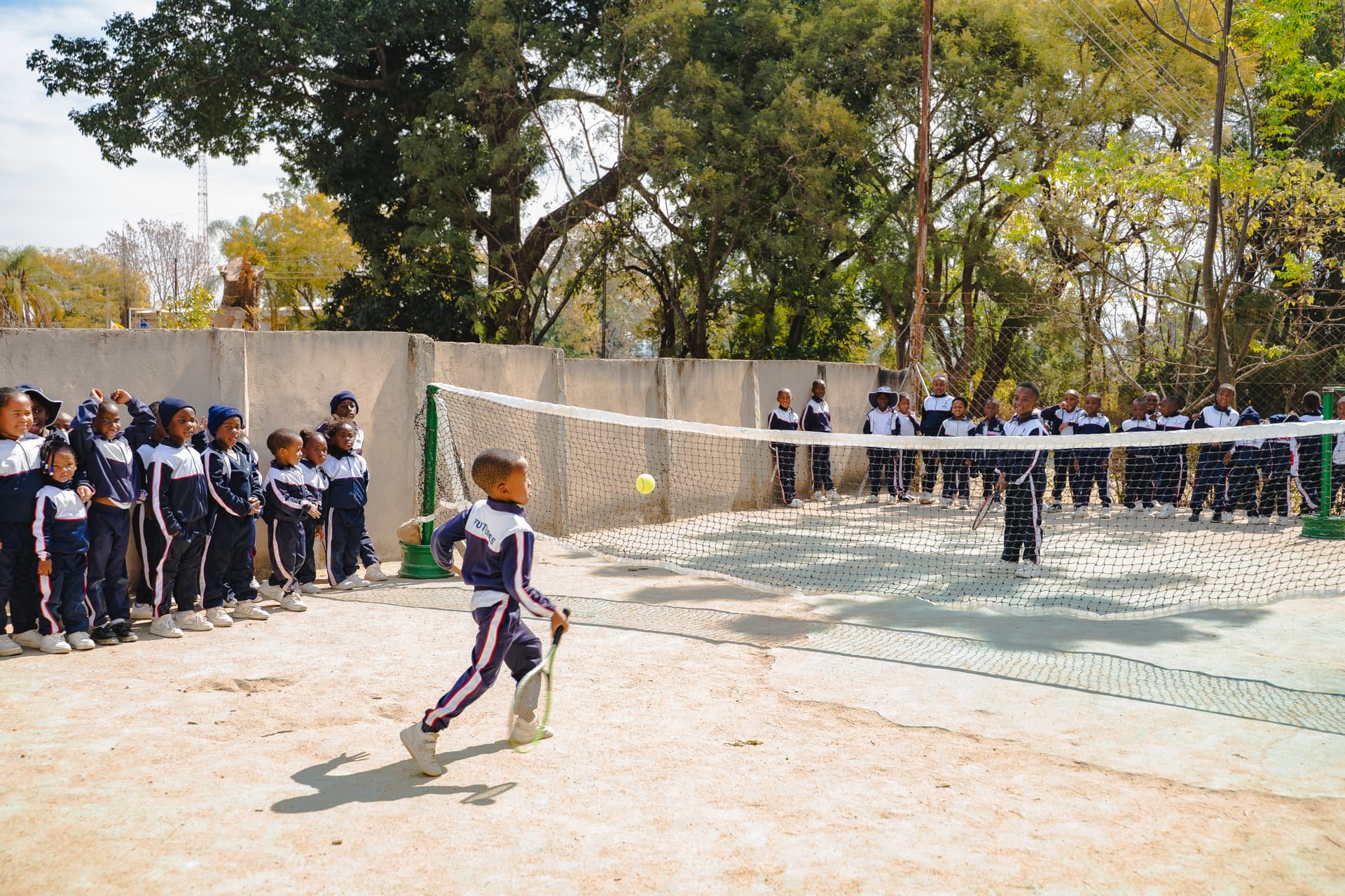 Primary pupils playing sport outdoors